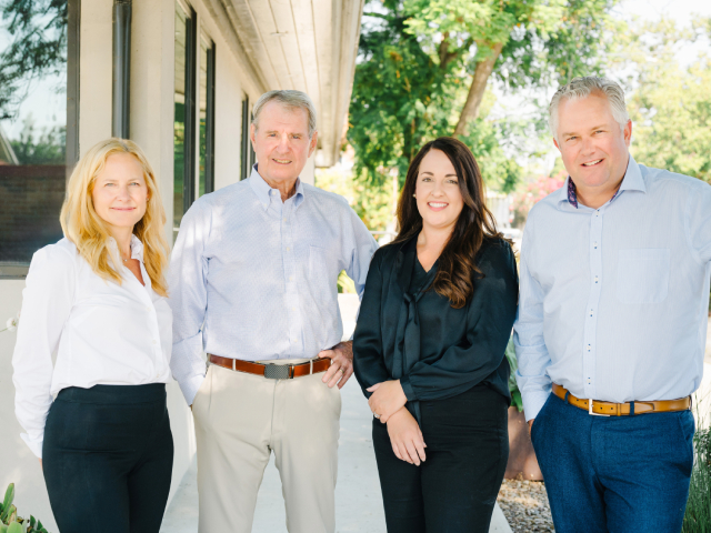 Glick Haupt Marino partner attorneys smiling outside the office